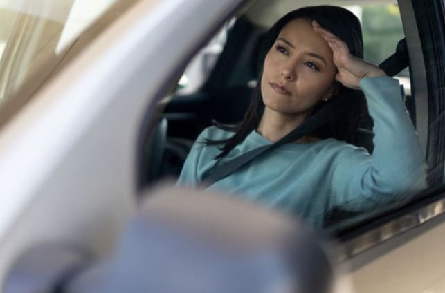Image of a Woman Stuck in Traffic for the Article Telehealth- Bridging Gaps in Modern Healthcare