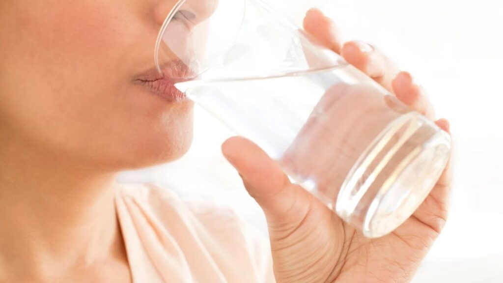 Person Drinking Water for the Article Beat the Heat Not Your Fun