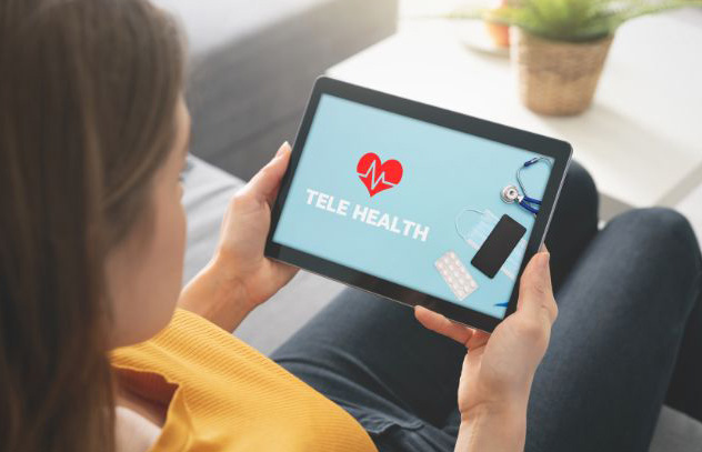 A woman using telehealth services on her tablet computer