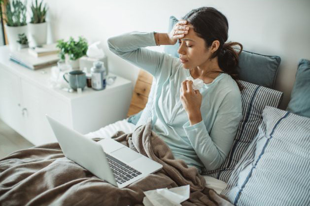 Woman with common cold in bed