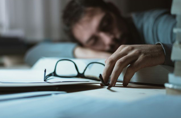 A person sleep at his work desk