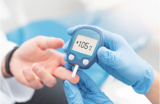 Medical professional checking blood sugar level of a patient