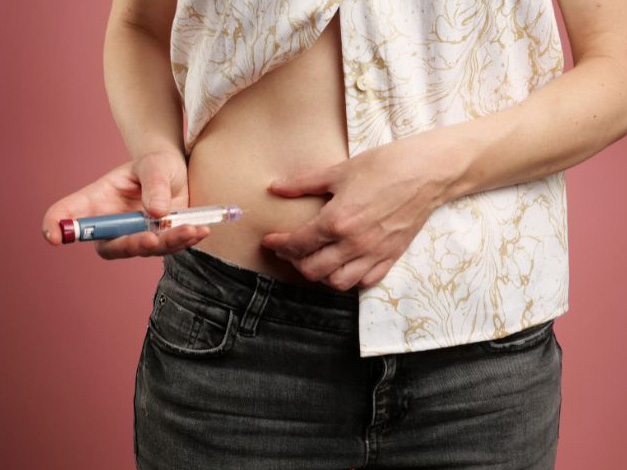 Woman injecting insulin to manage diabetes