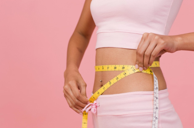 Photo of woman measuring her waistfor the blog post on the Best Peptides for Weight Loss