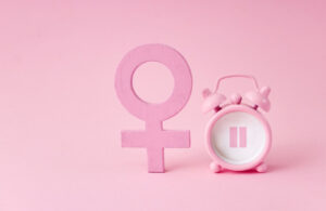 Image of menopause concept with female symbol and clock for the blog post on Healing Your Relationship with Food During Menopause