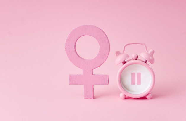 Image of menopause concept with female symbol and clock for the blog post on Healing Your Relationship with Food During Menopause