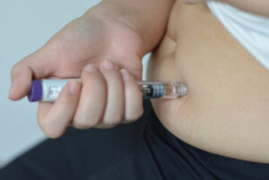 Photo of person using GLP-1 injectable for the blog post on GLP-1 skin changes