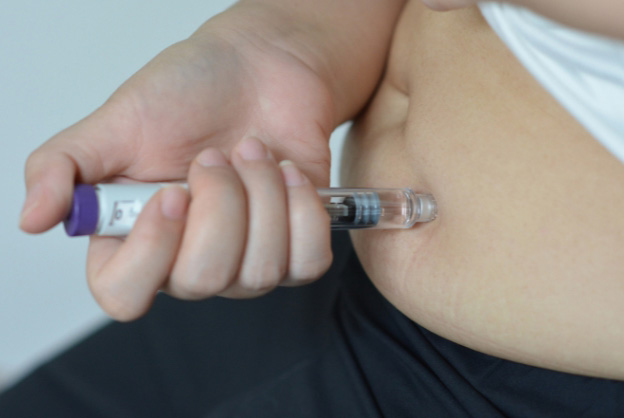 Photo of person using GLP-1 injectable for the blog post on GLP-1 skin changes