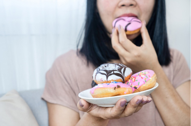woman binge eating for the blog post on Healing Your Relationship with Food During Menopause