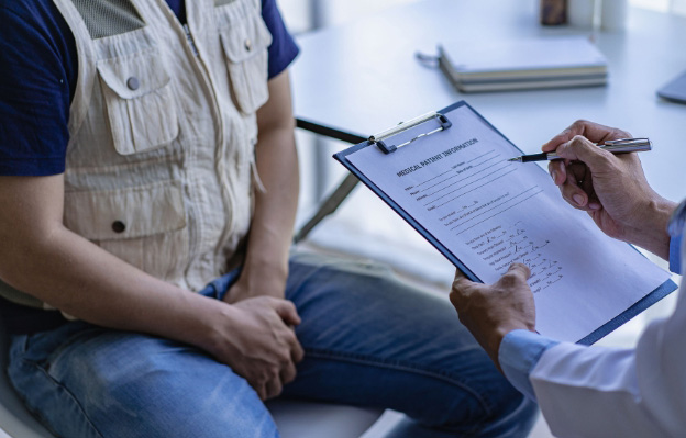 Medical professional and male testicular cancer patient discuss test results.
