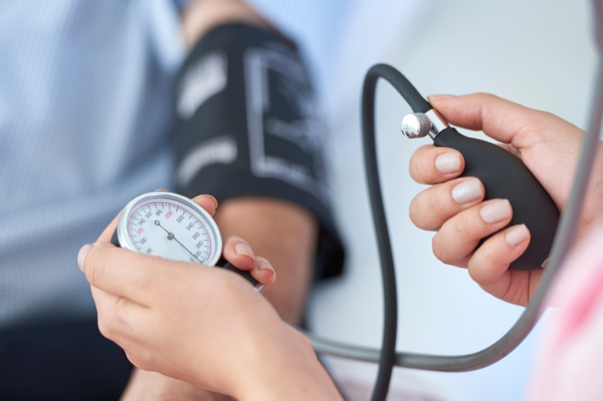Photo of a male patient getting his blood pressure